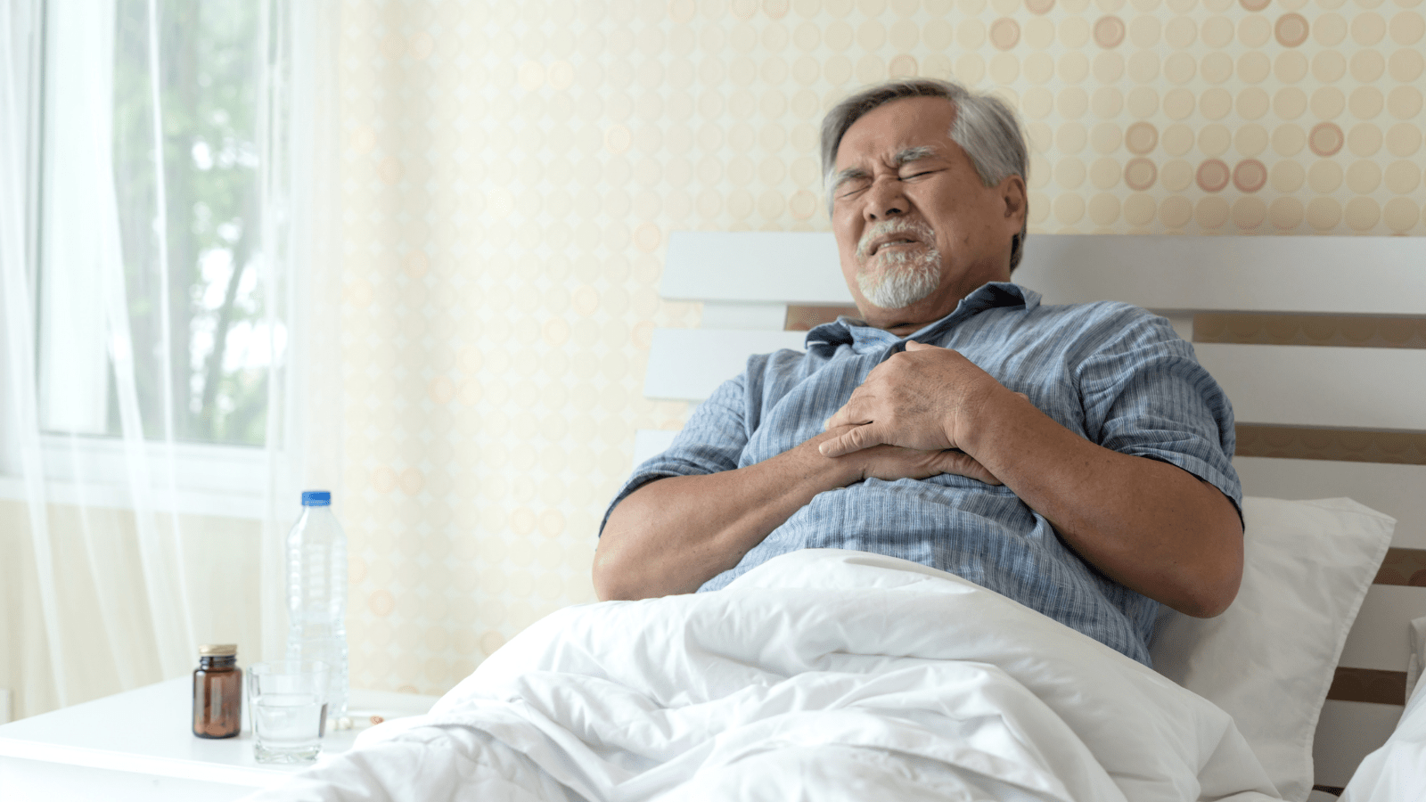 Man in Bed with Acid Reflux
