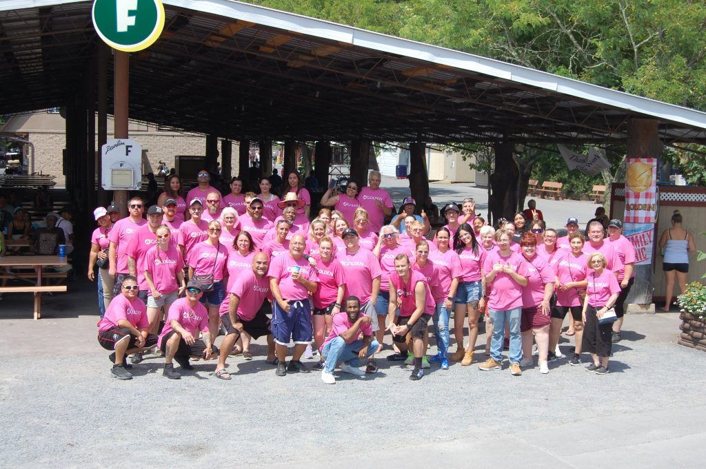 Group photo of the golden employees wearing breast cancer awareness shirts