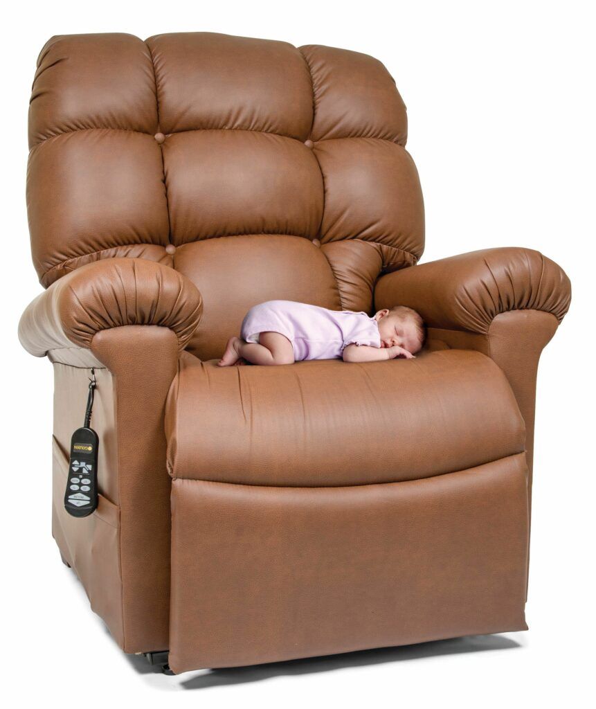 An image of a Golden power lift recliner in Brisa fabric with a baby sleeping on the seat